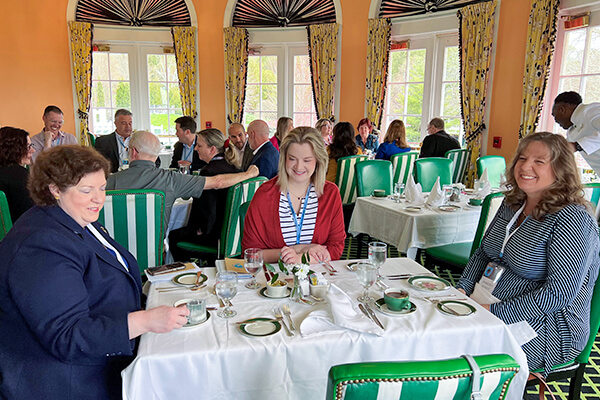 Conference goers enjoy breakfast in the main dining room of the Grand Hotel.