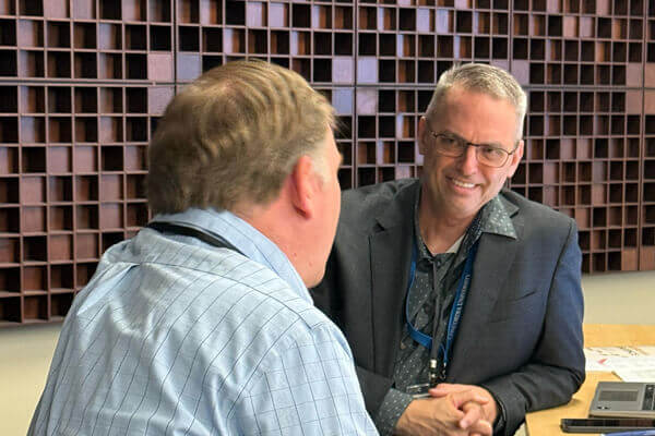 Conference goers engage in conversation.