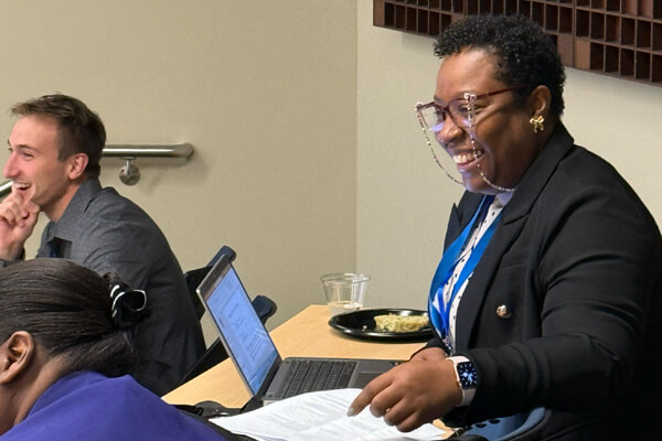 Conference goer smiling during presentation.